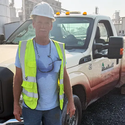 Stacy Herring standing in front of a Pine Knoll Truck.