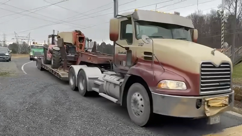 Pine Knoll Construction heavy hauling truck delivering material for site work.
