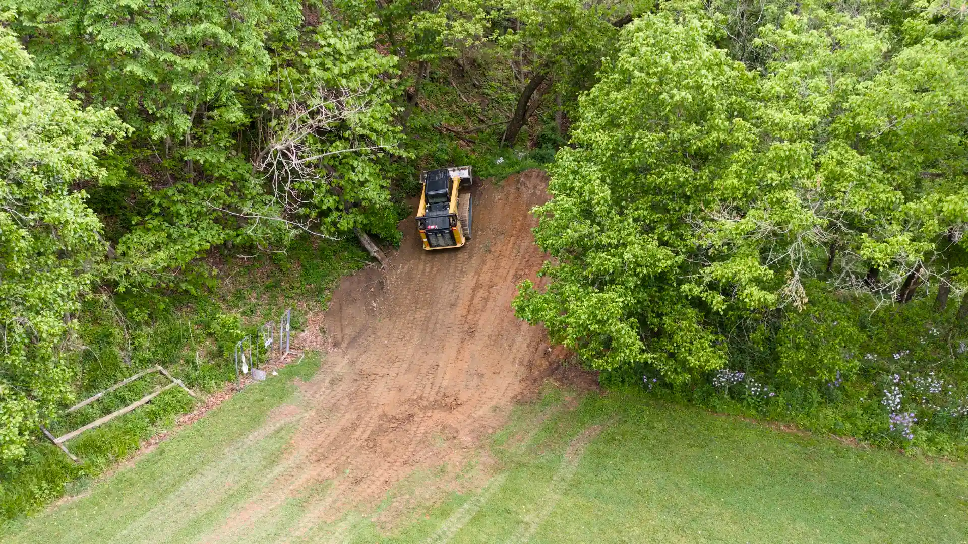 Aerial photo of a tracked skid steer grading a berm for the shooting range at the Winchester chapter Izaak Walton League