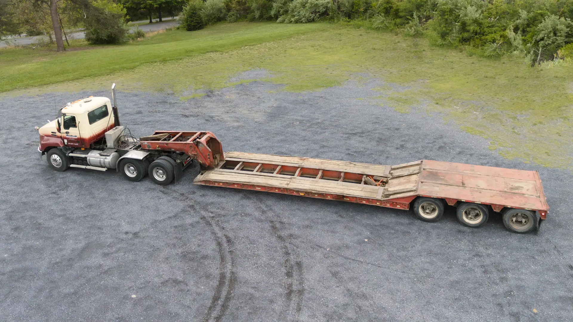 Trucking lowboy trailer at a jobsite picking up equipment for equipment hauling