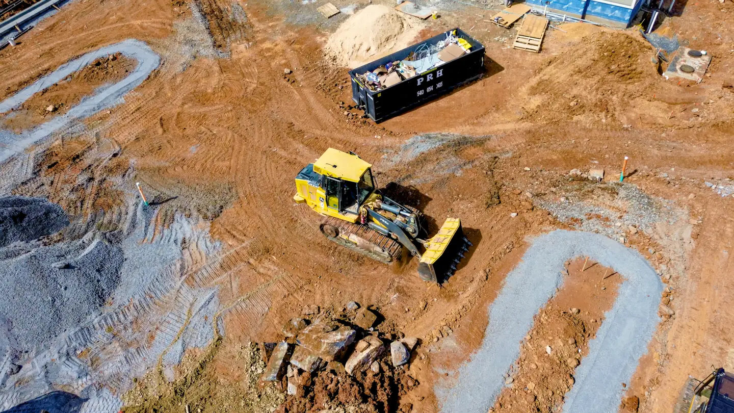 Track loader completing grading at a site work project in Winchester VA.